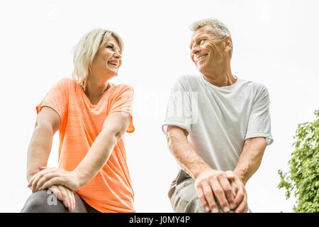 Couple smiling, low angle view. Stock Photo