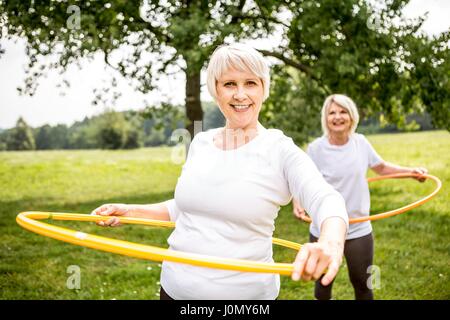 Two women with plastic hoops. Stock Photo