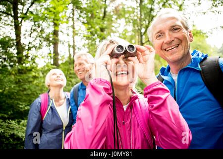 Senior woman looking through binoculars. Stock Photo