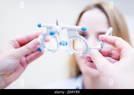Young woman having eye exam performed by optometrist. Stock Photo
