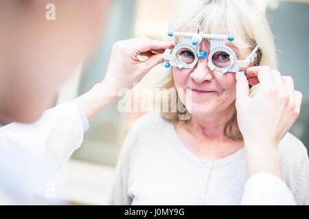 Senior woman having eye exam by optometrist. Stock Photo