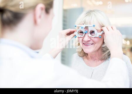 Senior woman having eye exam by optometrist. Stock Photo