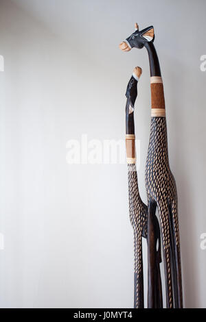 Scrimshaw giraffes from the tree on the background of white walls in a traditional Balinese style Stock Photo