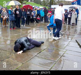 Buxton, Derbyshire 14th April 2017 Christians in Buxton celebrate Good Friday with a Walk of Witness from the Parish Church of St John to the pedestrianised shopping centre. They stop four times for hymns and reading from St Mark's Gospel. Here, young Christians give a mime performance showing the triumph of Good over Evil. Christians throughout the world celebrate Good Friday as the day when Jesus Christ was crucified, before rising again on Easter Sunday. Credit: John Fryer/Alamy Live News Stock Photo