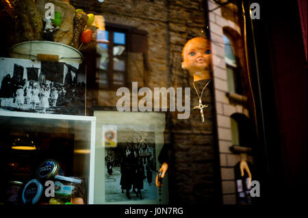 Bossost, Spain. 14th Apr, 2017. April 14, 2017 - Bossost, Lleida, Spain - A shop displays a doll dressed as a penitent in the village of Bossost during the Holy week. In the village of Bossost, Pyrenees mountains at Vall d'Aran region, neighbours take to the streets every year to held the holy friday procession. Bossost is the unic village that still holds this tradition in the Vall d'Aran region and has its origins from 1879. Credit: Jordi Boixareu/Alamy Live News Stock Photo