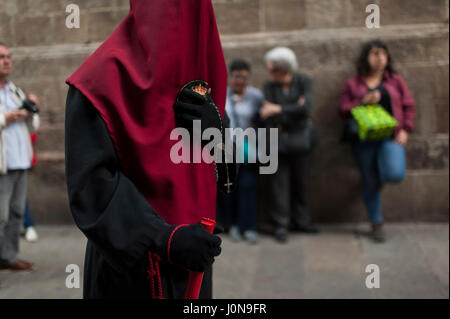 Spain, Barcelona. 14 April, 2017. A hooded penitent from 'Nuestra Señora de las Angustias' brotherhood takes part during a Holy Week procession in Barcelona, Spain Credit: Charlie Perez/Alamy Live News Stock Photo