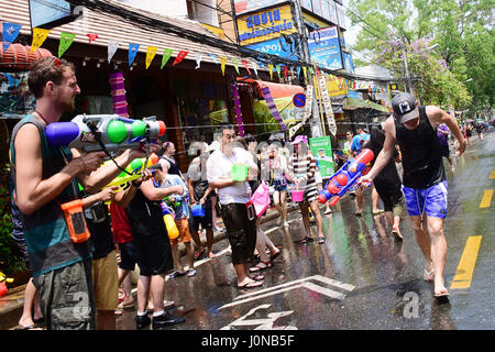 People are shooting each other with water gun and buckets full with water to celebrate the Songkran Water Festival as a symbol of happiness of Thai's 2560 New Year, in Chiang Mai, Thailand, April, 13th 2017 Stock Photo