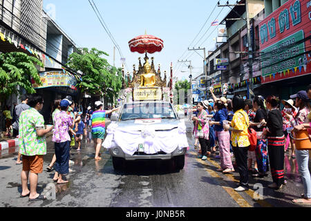 People in Chiang Mai, Thailand are throwing water to the Buddha Statue that carried by pick up car as a symbol of happiness to celebrate the Songkran Water Festival, April 13th 2017 Stock Photo