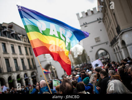 Munich, Germany. 15th Apr, 2017. Members of the peace movement carry a rainbow flag of the international peace movement during the Easter March in Munich, Germany, 15 April 2017. By holding Easter Marches throughout the german federal state of Bavaria, the protesters aim to raise awareness about regions across the world afflicted by war and crisis and to warn about the increasingly tense global political situation. Photo: Matthias Balk/dpa/Alamy Live News Stock Photo