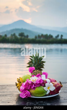 tropical exotic fruit and flowers selection plate at sunset in kampot cambodia