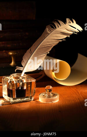 Vintage still life. Old inkstand with quill pen near scroll Stock Photo