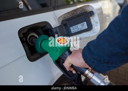 Filling up car with unleaded petrol at shell service station. Stock Photo