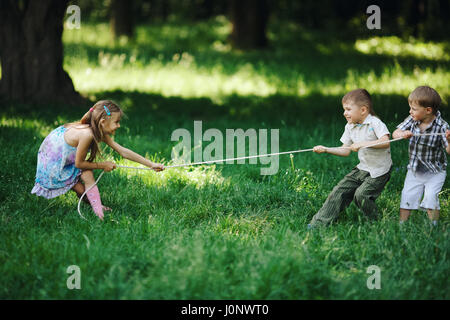 Rope pulling game portrait of kids in summer camp Stock Photo - Alamy