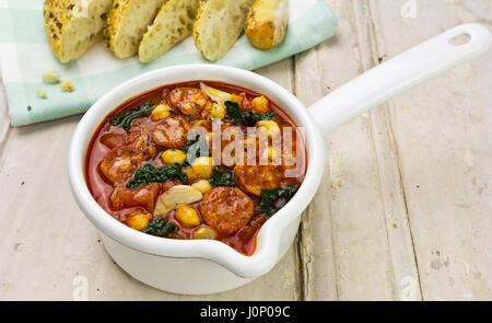 Chorizo kale chickpea soup with fresh bread Stock Photo