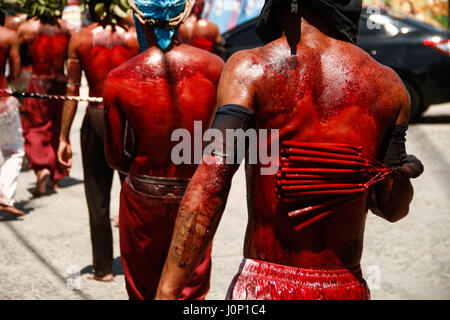 Pampanga, Philippines. 14th Apr, 2017. Hundreds of penitents walked under the midday sun in San Fernando, Pampanga, during the annual Good Friday Maleldo festival as they sacrifice their body for their faith. Flagellation and crucifixion has been discouraged by the Catholic church but devotees have continued the tradition for decades. Credit: J Gerard Seguia/Pacific Press/Alamy Live News Stock Photo