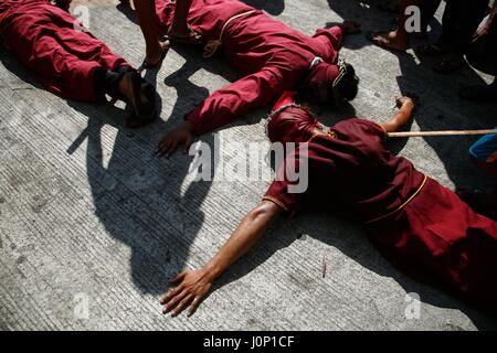 Pampanga, Philippines. 14th Apr, 2017. Hundreds of penitents walked under the midday sun in San Fernando, Pampanga, during the annual Good Friday Maleldo festival as they sacrifice their body for their faith. Flagellation and crucifixion has been discouraged by the Catholic church but devotees have continued the tradition for decades. Credit: J Gerard Seguia/Pacific Press/Alamy Live News Stock Photo