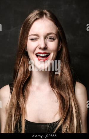 Portrait of young woman winking Stock Photo