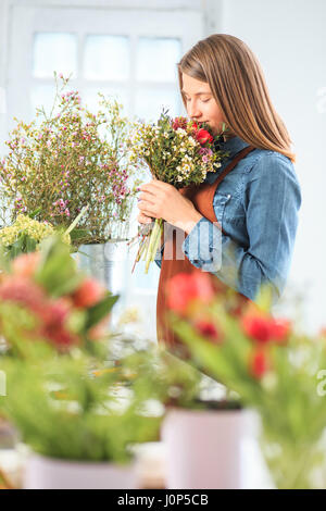 Florist at work: the young girl making fashion modern bouquet of different flowers Stock Photo