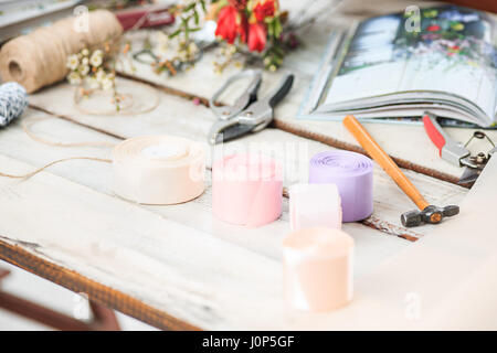 The florist desktop with working tools on white background Stock Photo