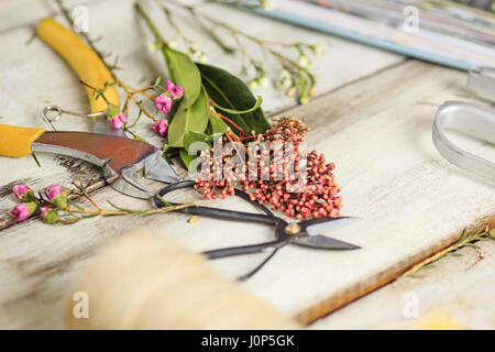 The florist desktop with working tools on white background Stock Photo