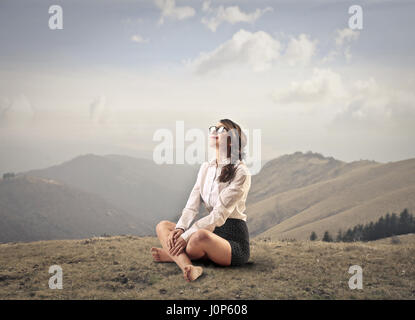 Businesswoman mediating in the nature Stock Photo
