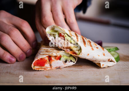 Fresh homemade chicken wrap tortilla on wood Stock Photo