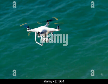 Low flying Drone hovering over water Stock Photo