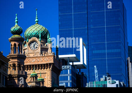 The clock tower of the Forum Theatre set against an office tower block in central Melbourne, Australia Stock Photo