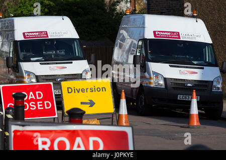Sign / signs for road closed / roads closure  caused by emergency electricity / electrical road works / roadwork / roadworks / utility company. Stock Photo