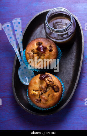 Date muffin with caramel sauce and cream Stock Photo