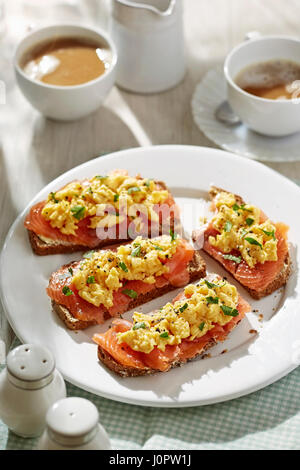 Brown soda bread with scrambled eggs and salmon Stock Photo
