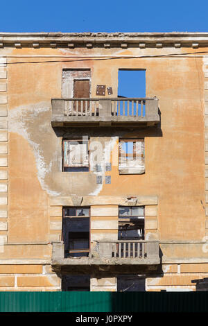 Exterior of an abandoned apartment buildings with broken windows in a ...