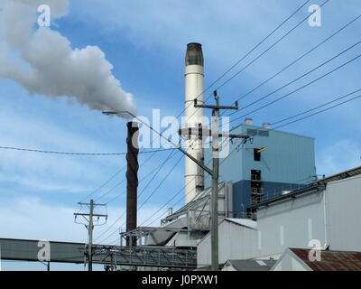 Smoke Stack of sugar mill with blue sky background Stock Photo