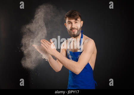 Young handyman or builder standing in the drive through in a hardware warehouse with a tablet in his hand looking at the camera Stock Photo