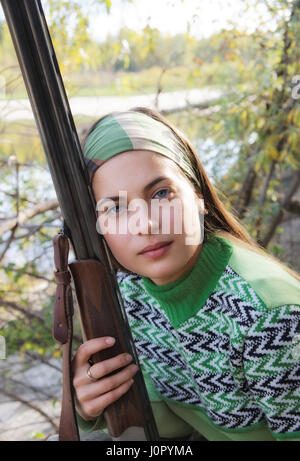 Portrait of a female hunter with a gun in Siberia Stock Photo