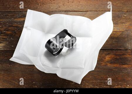 rough diamonds in a traditional diamond parcel on wooden background Stock Photo