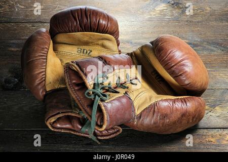 vintage boxing gloves on wooden background Stock Photo