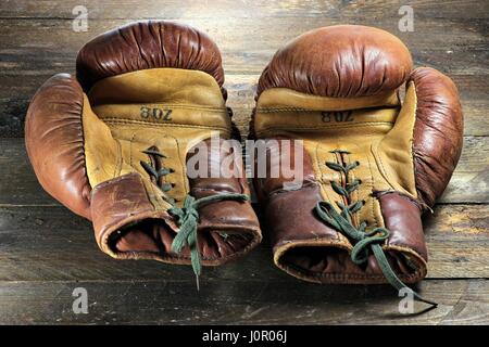 vintage boxing gloves on wooden background Stock Photo