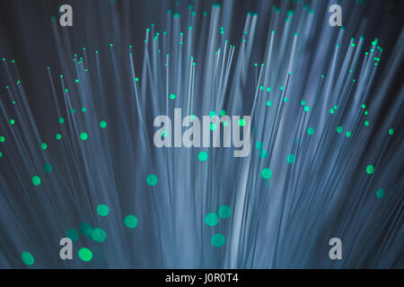 Green lights shining on a colour changing fibre optic lamp captured up close. Stock Photo