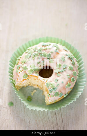 St. Patrick's Day glazed doughnut with green shamrocks Stock Photo