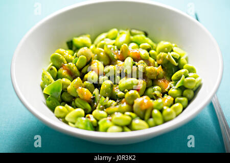 Edamame soya beans with peas and lemongrass with chilli dressing Stock Photo