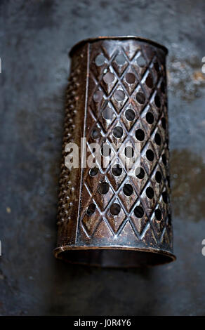 https://l450v.alamy.com/450v/j0r4y6/black-vintage-grater-on-dark-surface-j0r4y6.jpg