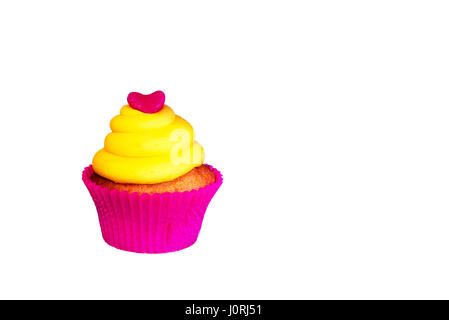 Pink cupcake with yellow cream and heart on top,isolated,cut out.Cupcake Uk.Pink and yellow cupcake on white background.Vibrant pastels cake,food. Stock Photo