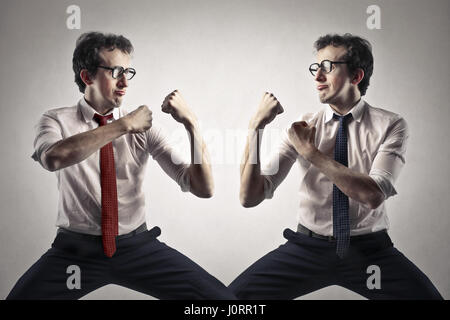 Businessman fighting with himself Stock Photo