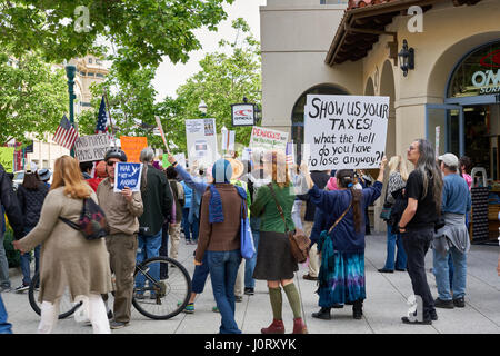 Santa Cruz, California, USA. 15th April, 2017. Protesters march downtown to demand the release of President Trump’s taxes. iris photoimages/Alamy Live News Stock Photo