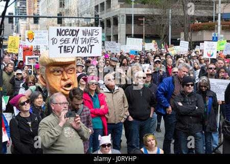 Seattle, Washington, USA. 15th April, 2017. Hundreds of protestors attended Tax March Seattle, a rally and sister march to the National Tax March taking place in over 180 communities across the U.S. Activists are demanding that President Trump release his tax returns and reveal his business dealings, financial ties, and any potential conflicts of interests. Credit: Paul Gordon/Alamy Live News