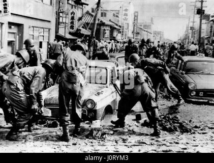 Jun. 22, 1964 - Japanese earthquake disaster: The city of Nigata was reduced to a blazing shambles by the earthquake which struck last Tuesday, isolating it from the rest of Japan, as railway lines buckled and the runway of the airport partly disappeared. Now there is no water, electricity or sewerage, and thousands are homeless. The port of Nigata, one of the principal oil refining cities, suffered a double catastrophy as oil tanks burst spreading blazing oil over hundreds of houses nearby, destroying 291 of them. The 90 oil tanks which went up in flames contained 400,000 kilolitres. So far 2 Stock Photo