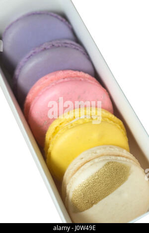 Box of macarons of various flavors:  salted caramel, lemon, birthday cake, and passion fruit Stock Photo