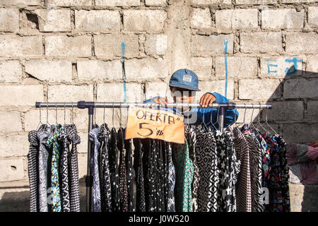 A young boy selling clothes at the market place in Otavalo, Ecuador. Stock Photo