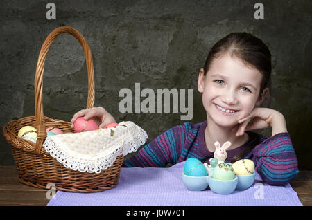 Little girl with basket of Easter eggs Stock Photo